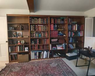 Wooden Bookshelf Unit with Assorted Books and Decorative Items
