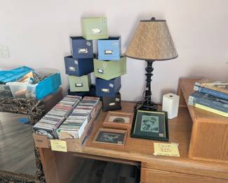 CD's, lamp, storage box, Apple router