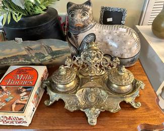 Ornate double inkwell desk set with detailed decorative base and figural motif. Classic antique-style piece with rich character and strong display appeal.