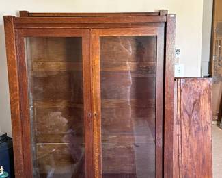 Vintage display cabinet with sliding glass panels and solid wood construction. Classic piece with clean lines and practical display use. This piece has wooden shelves,  as shown next to the cabinet.