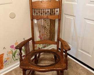 Antique rocking chair with spindle back and nicely aged wood tone. Sturdy piece with classic form and character—ready for a new seat.