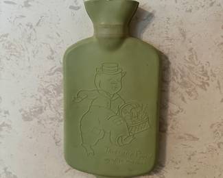 Vintage rubber hot water bottle featuring a Little Jack Horner motif in soft green. Fun, nostalgic piece with great display appeal.