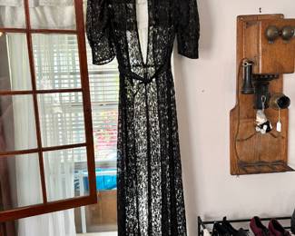 Vintage black lace gown in a 1930s style with a long silhouette and open back design. Elegant piece with soft drape and classic vintage appeal.