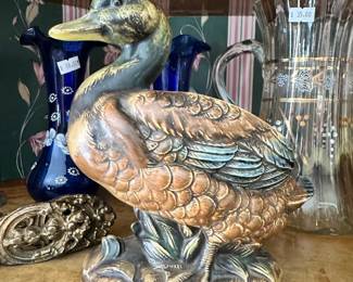 Napcoware duck figurine featuring detailed feather work and a rich multitone glaze. Eye-catching vintage display piece with classic charm.