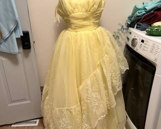 1962 vintage prom gown in pale yellow with a full skirt and lace detailing. Graceful mid-century piece with soft drape and elegant form.