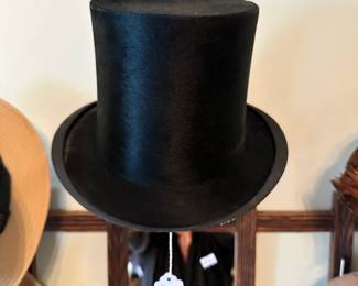 Early 20th-century top hat (circa 1910) with traditional tall crown design. Classic accessory with period charm and decorative appeal.