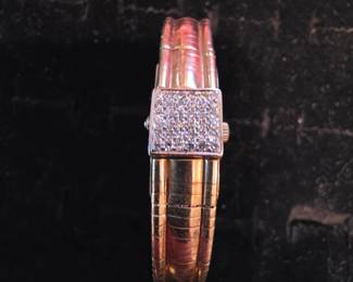 I'm and beautiful 14K bracelet with Diamonds. Open me up and I'm a watch !