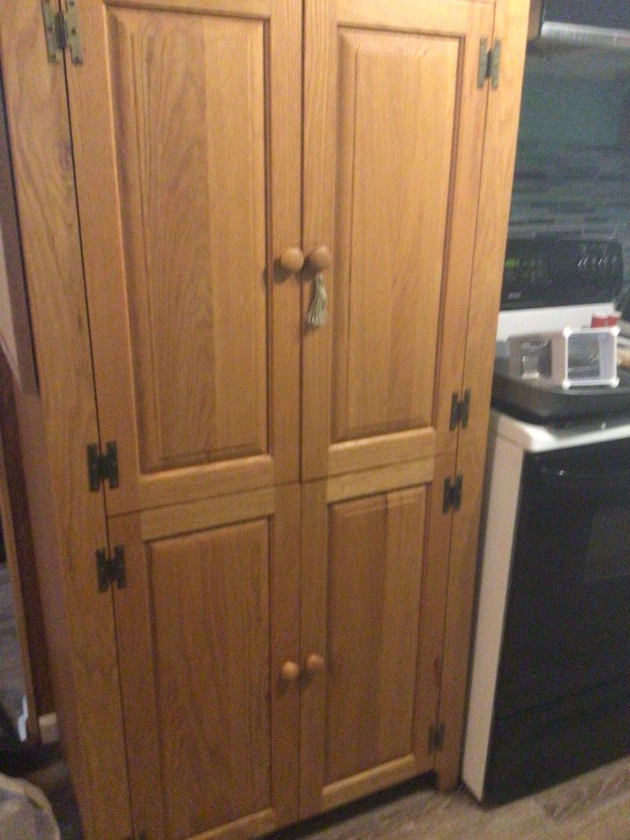 Wood pantry cabinet 140.