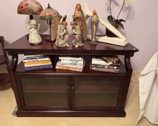 Very nice entertainment center..  various religious statues 