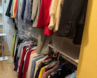 Closet full of woman’s suits, shirts, blouses, and lots of accessories 