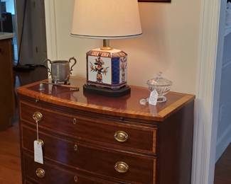 Beautiful Bow Front , Banded Top MahoganyBachelor Chest with pull out dressing slide with 4 inlaid banded drawers, attributed to Baker.