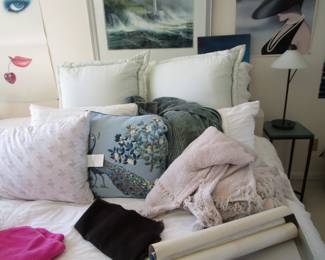 Bed with lots of throws and pillows