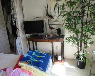 Antique table with small TV, plant, vintage beach towels