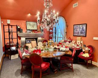 Large living area turned dining packed with crystal, china, fine art, classy furniture, and Christmas.