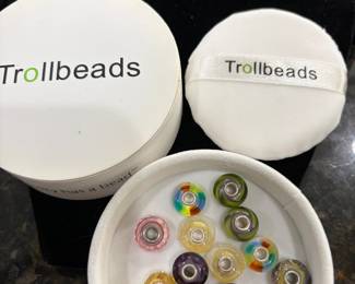 Trollbeads are high-quality, handcrafted interchangeable jewelry pieces—charms, beads, and spacers—originated in Denmark in 1976  Trollbeads Trollbeads  +1 . Founded by the Nielsen/Aagaard family, they are designed to be collected and worn on bracelets, necklaces, or earrings, often featuring themes from mythology, nature, and storytelling