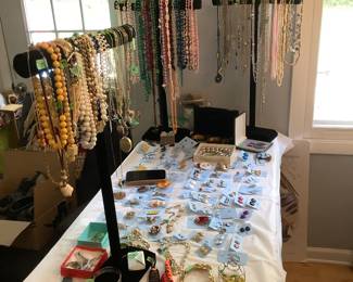 Table full of costume jewelry.  Also view master with slides