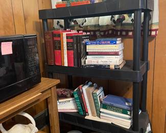 Microwave, cart, and books