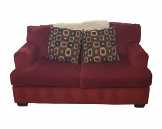 Red Corduroy Sofa with Geometric Patterned Pillows