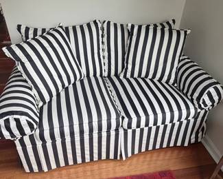 Black and White Striped Sofa with Rolled Arms and Skirted Base