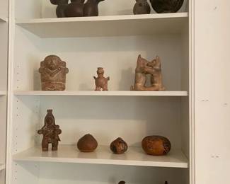 Four Shelves Of Egyptian Themed Decor