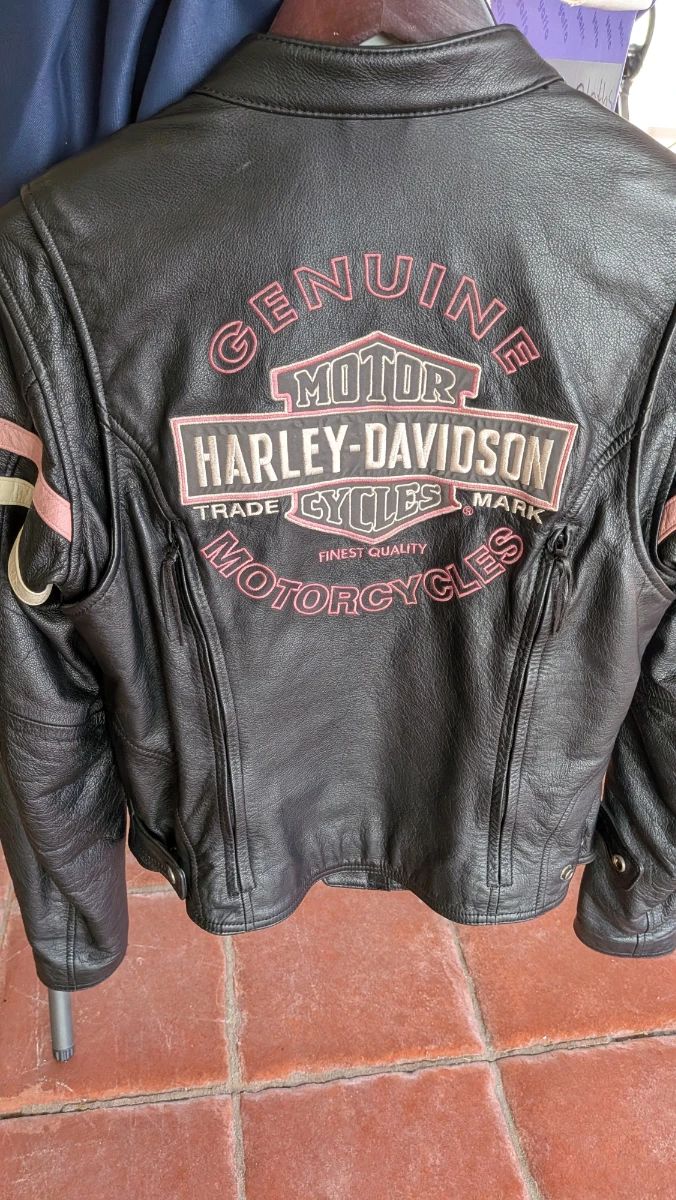 Women's Harley-Davidson "Genuine Motor Cycles" Leather Jacket (likely part of or related to the Pink Label collection). This is a sought-after style for estate sales because the pink embroidery appeals to a specific niche of female riders. So you best be first in line ladies!