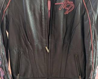This is a high-quality Harley-Davidson "Pink Label" Limited Edition leather motorcycle jacket. Based on the "Winged Heart" embroidery on the back and the signature script on the sleeves, this was part of a specific collection supporting breast cancer awareness.