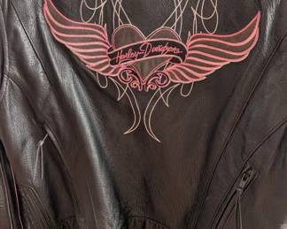 This is a high-quality Harley-Davidson "Pink Label" Limited Edition leather motorcycle jacket. Based on the "Winged Heart" embroidery on the back and the signature script on the sleeves, this was part of a specific collection supporting breast cancer awareness.