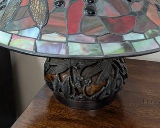 Meyda Home Decorative 16.5"H Dragonfly Cut Agata Table Lamp, featuring a dragonfly-themed stained glass shade and a sculpted metal base. 