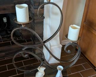 three-tier scrolled bent iron and brass candelabra holder, designed to hold three pillar candles. 