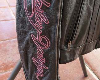 This is a high-quality Harley-Davidson "Pink Label" Limited Edition leather motorcycle jacket. Based on the "Winged Heart" embroidery on the back and the signature script on the sleeves, this was part of a specific collection supporting breast cancer awareness.