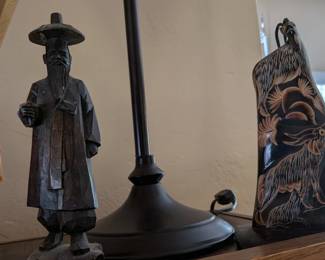 vintage Asian hand-carved wood figurine, likely depicting a scholar or philosopher such as Confucius. It features a dark finish and intricate carving details typical of hand-crafted folk art. 2nd photo:decorative carving made from a buffalo horn, often featuring intricate scenes like dragons or phoenixes.