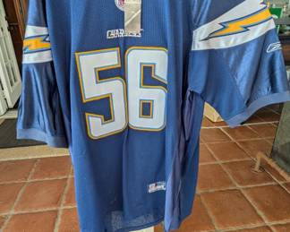 Shawne Merriman #56 San Diego Chargers jersey from the Reebok era. Merriman, nicknamed "Lights Out," was one of the most dominant linebackers of the mid-2000s, known for his explosive hits and signature dance.