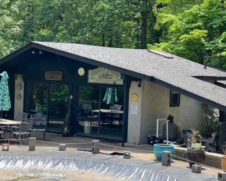 Pool house where the antique cast iron table & chairs are and animal antlers. 