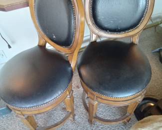 Swivel bar stools with leather seats.