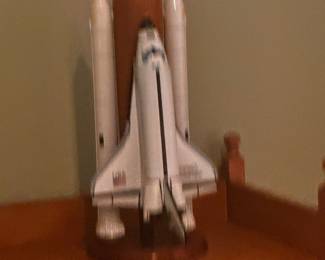  a handcrafted mahogany wood model of a NASA Space Shuttle in its full launch configuration, including the orbiter, external tank, and solid rocket boosters. 