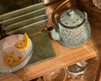 Crate &Barrell green bowls and tray. decorative light green cast iron teapot featuring an embossed leaf design and a metallic handle.  Material: Durable cast iron. 