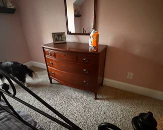 . 1930s mahogany piece featuring a bow-front design and matched mirror. 