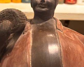 item is a piece of Chulucanas pottery from Peru, featuring a signature and date on the bottom. Artist: The piece is signed "J. Sandoval Adanaque," likely referring to a member of the Sandoval family known for this ceramic style. Origin: Chulucanas pottery is a traditional craft from the Piura region of Peru, known for its distinctive black-and-white patterns and clay techniques. Date: It is dated 1994.