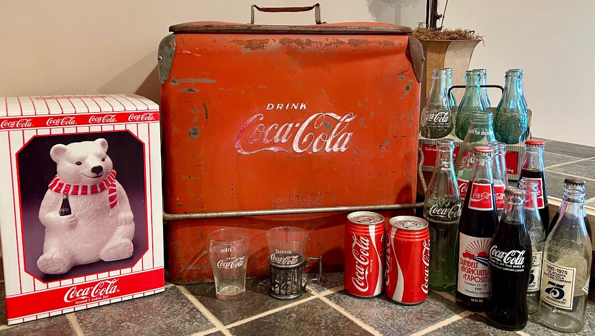 Original vintage Coca-Cola cooler with bottles, glasses and advertising collectibles