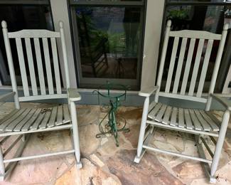 Pair of painted wooden rocking chairs with slat backs.