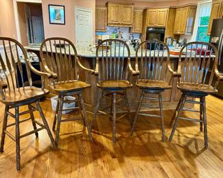 Set of 5 wood bar stools with spindle backs and arms.