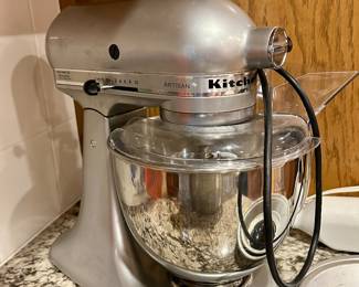 KitchenAid Artisan stand mixer with glass bowl.