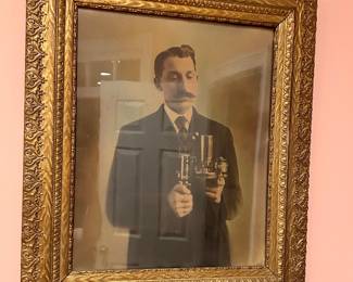 Antique sepia portrait of gentleman with scientific instrument in ornate gold frame