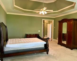 Carved wood sleigh bed with rolled headboard and footboard