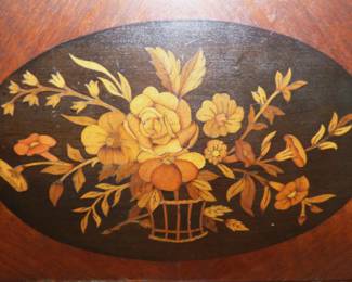 CLOSE UP OF INLAID FLOWER MOTIF ON COTTAGE STYLE BEDROOM FURNITURE