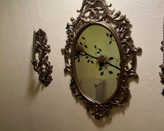 Gold framed mirror with pair of candle hold