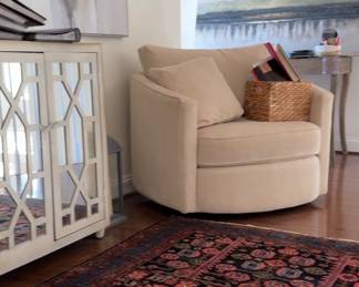 Hand knotted rug and swivel club chair