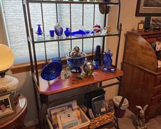 Wrought Iron Bakers Rack with Assorted Decorative Glassware and Figurines