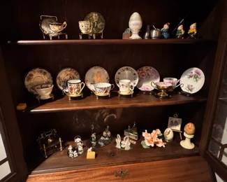 Collection of Porcelain Teacups and Saucers with Decorative Plates and Figurines