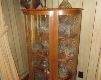 Vintage oak curved glass china cabinet full of Fostoria